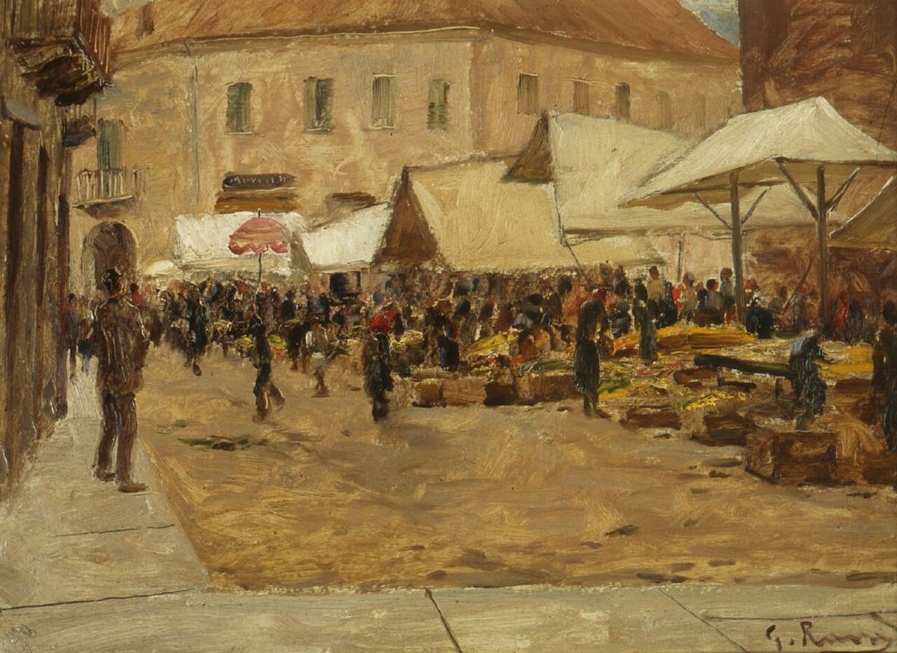 A busy open-air market in Alba, with canvas stalls, a pink parasol and crowds of shoppers among heaps of produce before pale stone houses.