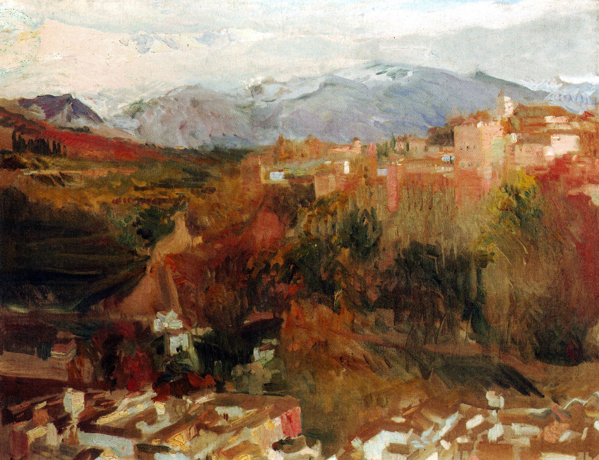 An autumn view of the reddish towers of the Alhambra on its wooded hill, with the snow-capped Sierra Nevada rising behind.
