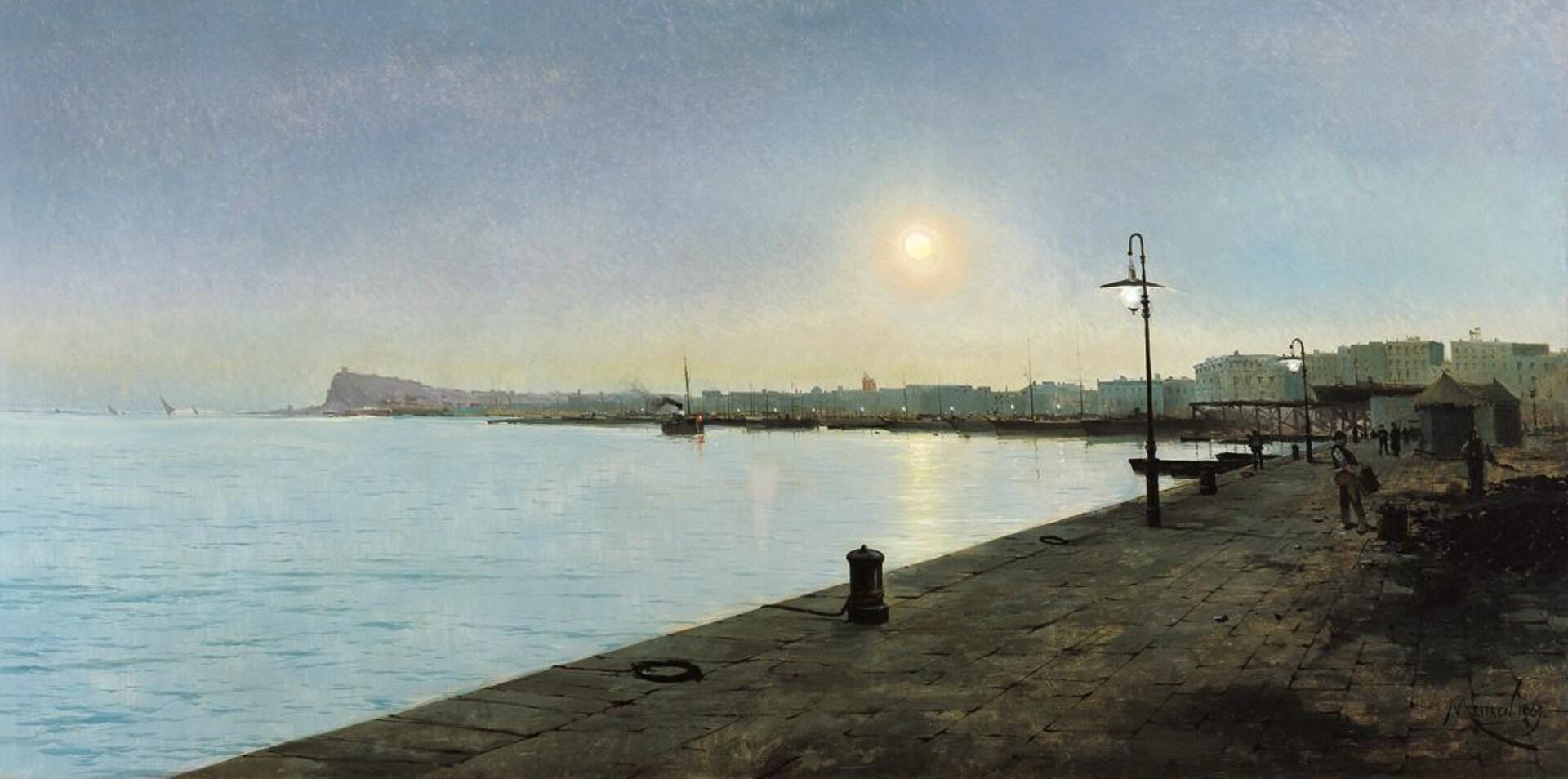 A stone quay in Barcelona harbour with street lamps, a bollard and a few figures, ships along the waterfront and a headland, probably Montjuïc, on the horizon under a hazy glowing sky.