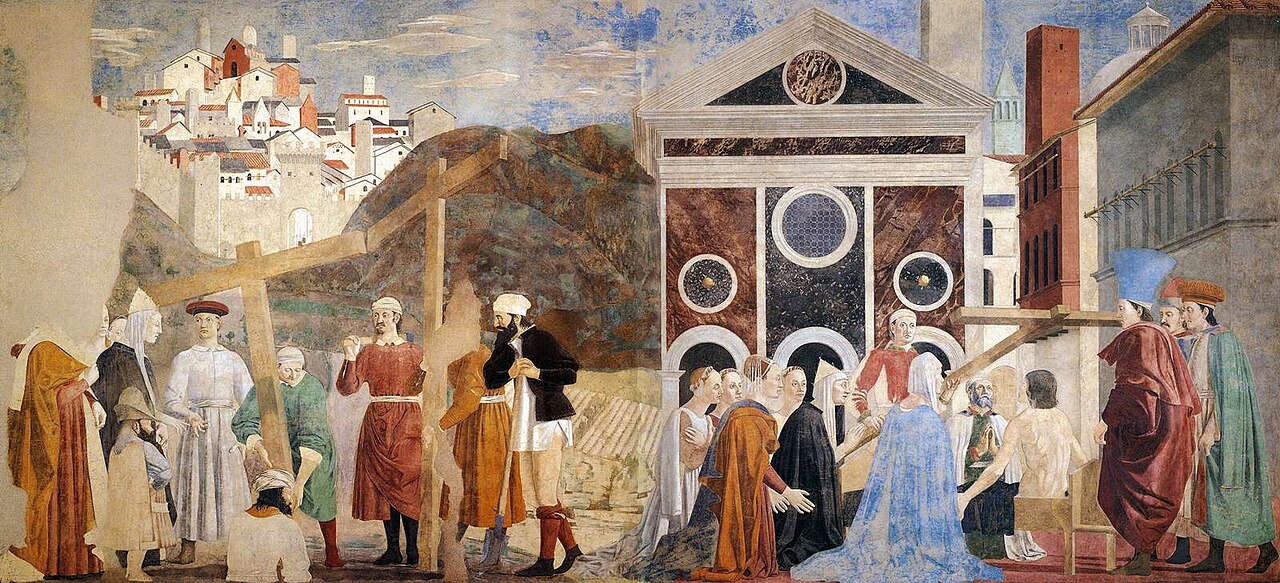 Renaissance fresco with a walled hill town of pale and red towers above workers lifting wooden crosses on the left, and women kneeling before a marble church front on the right.
