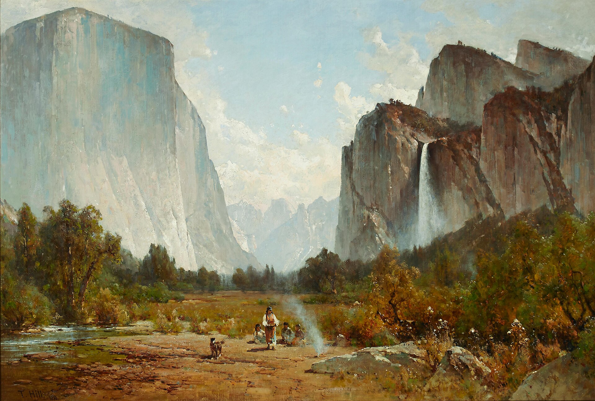 El Capitan's sheer granite wall at left and Bridalveil Fall pouring from the cliffs at right frame Yosemite Valley, with distant snowy peaks and autumn trees below.